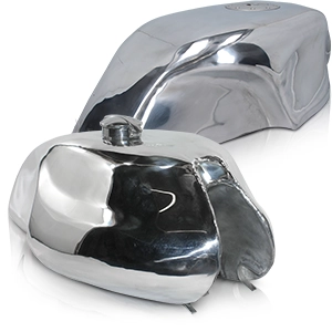 Two polished metal petrol tanks for motorbikes in classic cafe racer style.